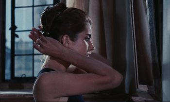 Movie still from “Accident” (1967), directed by Joseph Losey – A beautiful young lady sitting in front of a window; Close Up shot, Over the shoulder angle