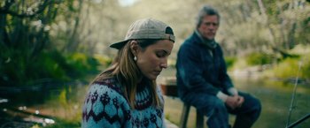Movie still from “Acidman” (2022), directed by Alex Lehmann – A man and a woman sitting on a bench; Medium shot, Over the shoulder angle