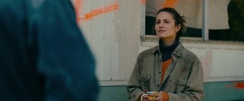 Movie still from “Acidman” (2022), directed by Alex Lehmann – A woman holding a cup in her hands; Close Up shot, Over the shoulder angle