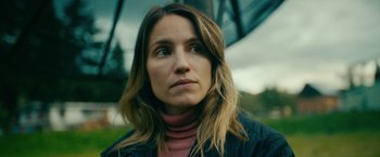 Movie still from “Acidman” (2022), directed by Alex Lehmann – A person with long brown hair; Close Up shot, Low angle