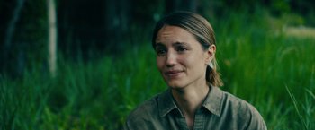 Movie still from “Acidman” (2022), directed by Alex Lehmann – A person wearing a green shirt; Close Up shot, Over the shoulder angle