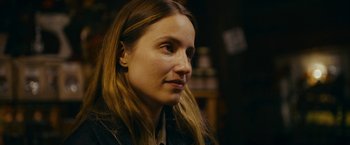 Movie still from “Acidman” (2022), directed by Alex Lehmann – A person with long blonde hair; Close Up shot, Over the shoulder angle