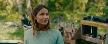 Movie still from “Acidman” (2022), directed by Alex Lehmann – A woman standing in front of a wooden fence; Close Up shot, Over the shoulder angle
