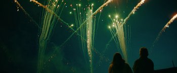Movie still from “Acidman” (2022), directed by Alex Lehmann – A person standing in front of a bunch of fireworks; Extreme Wide shot, Low angle