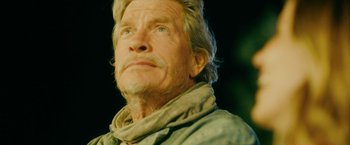 Movie still from “Acidman” (2022), directed by Alex Lehmann – An older man with a beard and a scarf; Close Up shot, Low angle