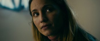 Movie still from “Acidman” (2022), directed by Alex Lehmann – A woman's face looking into the distance; Close Up shot, Low angle