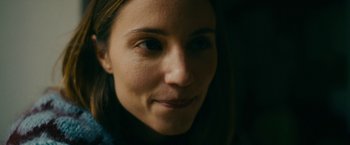 Movie still from “Acidman” (2022), directed by Alex Lehmann – A woman's face in the dark; Close Up shot, Over the shoulder angle