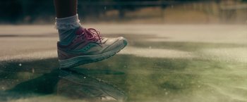 Movie still from “Acidman” (2022), directed by Alex Lehmann – A pair of feet wearing pink and white sneakers; Extreme Close Up shot, Low angle