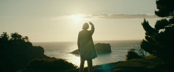 Movie still from “Acidman” (2022), directed by Alex Lehmann – A woman standing on a cliff looking out at the ocean; Extreme Wide shot, Low angle