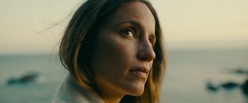 Movie still from “Acidman” (2022), directed by Alex Lehmann – A woman's face looking into the distance; Close Up shot, Low angle