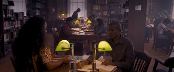 Movie still from “Acrimony” (2018), directed by Tyler Perry – A group of people sitting at a table in a library; Wide shot, High angle