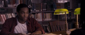Movie still from “Acrimony” (2018), directed by Tyler Perry – A man sitting at a table in front of a lamp; Medium shot, High angle
