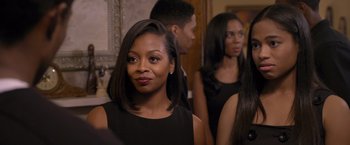 Movie still from “Acrimony” (2018), directed by Tyler Perry – A group of people standing next to each other in front of a mirror; Close Up shot, Over the shoulder angle