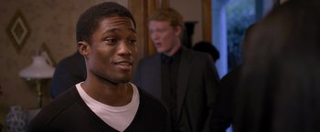 Movie still from “Acrimony” (2018), directed by Tyler Perry – A man standing next to another man in a room; Close Up shot, Over the shoulder angle