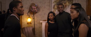 Movie still from “Acrimony” (2018), directed by Tyler Perry – A man and a woman standing next to each other in a room; Medium shot, Over the shoulder angle