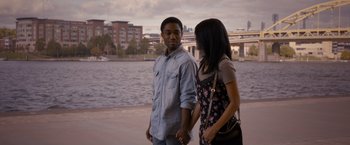 Movie still from “Acrimony” (2018), directed by Tyler Perry – A man and a woman standing next to a body of water; Medium shot, Over the shoulder angle