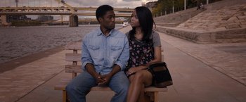 Movie still from “Acrimony” (2018), directed by Tyler Perry – A man and a woman sitting on a wooden bench; Medium shot, High angle