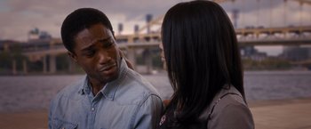Movie still from “Acrimony” (2018), directed by Tyler Perry – A man and a woman standing next to each other in front of a bridge; Close Up shot, Over the shoulder angle