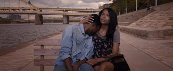 Movie still from “Acrimony” (2018), directed by Tyler Perry – A man and a woman sitting next to each other on a pier; Medium shot, High angle