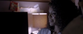 Movie still from “Acrimony” (2018), directed by Tyler Perry – A person with curly hair smiling; Close Up shot, Over the shoulder angle