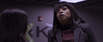 Movie still from “Acrimony” (2018), directed by Tyler Perry – A woman in a black jacket and a red shirt; Close Up shot, Low angle