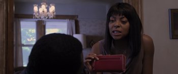 Movie still from “Acrimony” (2018), directed by Tyler Perry – A woman is holding a red purse in front of a man; Close Up shot, Over the shoulder angle