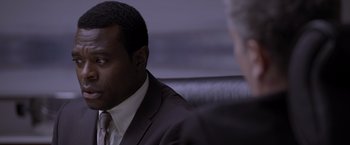 Movie still from “Acrimony” (2018), directed by Tyler Perry – A man in a suit and tie sitting in front of another man; Close Up shot, Over the shoulder angle