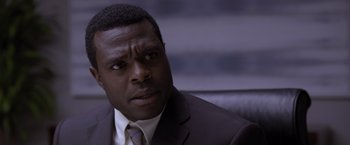 Movie still from “Acrimony” (2018), directed by Tyler Perry – A person wearing a suit and tie; Close Up shot, Low angle