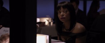 Movie still from “Acrimony” (2018), directed by Tyler Perry – A woman sitting at a table in front of a lit candle; Close Up shot, Over the shoulder angle