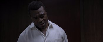 Movie still from “Acrimony” (2018), directed by Tyler Perry – A man in a white dress shirt is looking down; Close Up shot, Low angle