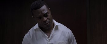Movie still from “Acrimony” (2018), directed by Tyler Perry – A man in a white dress shirt is looking down; Close Up shot, Low angle