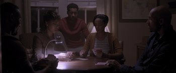 Movie still from “Acrimony” (2018), directed by Tyler Perry – A group of people sitting at a table playing cards; Medium shot, High angle