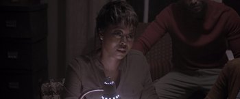 Movie still from “Acrimony” (2018), directed by Tyler Perry – A woman sitting on a couch looking at a lamp; Close Up shot, Over the shoulder angle