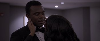 Movie still from “Acrimony” (2018), directed by Tyler Perry – A man in a tuxedo and a woman in a black suit; Close Up shot, Over the shoulder angle
