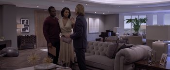 Movie still from “Acrimony” (2018), directed by Tyler Perry – A group of people standing in a living room talking; Medium shot, Over the shoulder angle