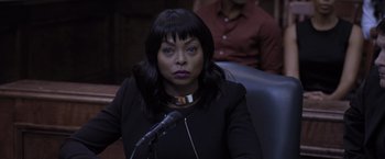 Movie still from “Acrimony” (2018), directed by Tyler Perry – A woman sitting in front of a microphone in a courtroom; Close Up shot, Over the shoulder angle