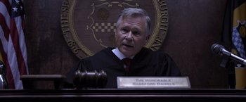 Movie still from “Acrimony” (2018), directed by Tyler Perry – A judge sitting in front of a judge's bench; Medium shot, High angle