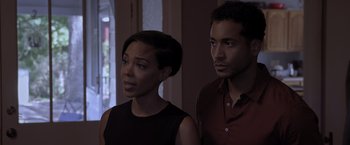 Movie still from “Acrimony” (2018), directed by Tyler Perry – A woman standing next to a man in front of a window; Medium shot, Over the shoulder angle