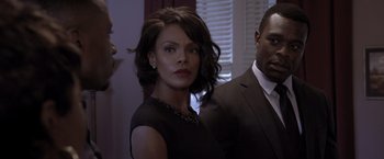 Movie still from “Acrimony” (2018), directed by Tyler Perry – A man and a woman standing next to each other in a room; Medium shot, Over the shoulder angle