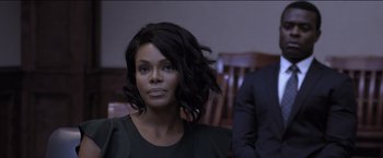 Movie still from “Acrimony” (2018), directed by Tyler Perry – A woman sitting in front of a man in a suit; Close Up shot, Over the shoulder angle