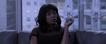 Movie still from “Acrimony” (2018), directed by Tyler Perry – A woman smoking a cigarette while sitting in a chair; Close Up shot, Over the shoulder angle