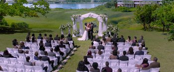 Movie still from “Acrimony” (2018), directed by Tyler Perry – A couple getting married under a wedding arch; Extreme Wide shot, High angle