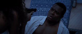 Movie still from “Acrimony” (2018), directed by Tyler Perry – A man with a gun pointed at a man with a shirt on; Close Up shot, Over the shoulder angle