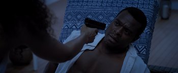 Movie still from “Acrimony” (2018), directed by Tyler Perry – A woman holding a gun up to a man's face; Close Up shot, Over the shoulder angle