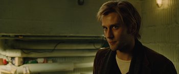 Movie still from “Across the Universe” (2007), directed by Julie Taymor – A person wearing a jacket; Close Up shot, Over the shoulder angle