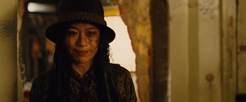 Movie still from “Across the Universe” (2007), directed by Julie Taymor – A woman wearing a brown hat and a brown shirt; Close Up shot, Low angle