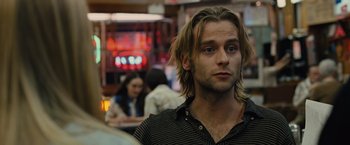 Movie still from “Across the Universe” (2007), directed by Julie Taymor – A person with long blonde hair; Close Up shot, Over the shoulder angle