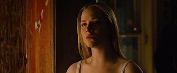 Movie still from “Across the Universe” (2007), directed by Julie Taymor – A beautiful young blond haired woman in front of a mirror; Close Up shot, Low angle