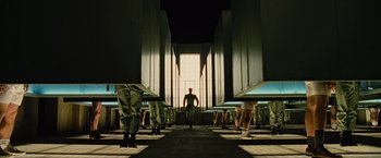 Movie still from “Across the Universe” (2007), directed by Julie Taymor – A group of people standing in a room; Wide shot, Low angle