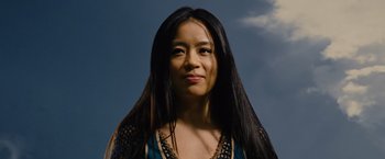 Movie still from “Across the Universe” (2007), directed by Julie Taymor – A person with long black hair; Close Up shot, Low angle